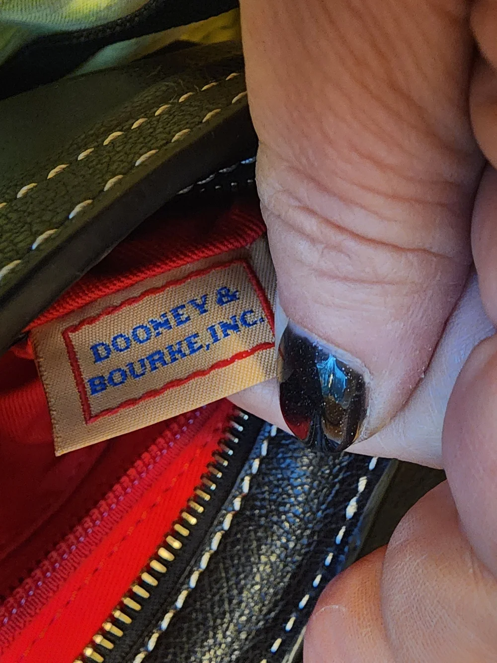 vintage Dooney & Bourke black leather shoulder bag featuring gold-tone hardware